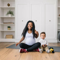 Woman wearing long maternity tank top in lavender.