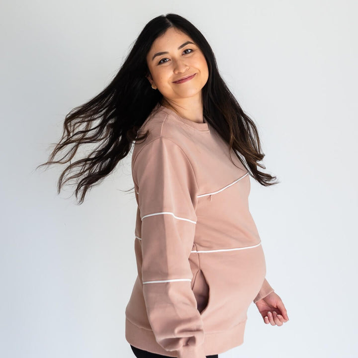 Woman wearing black nursing hoodie from Canadian maternity store, Joyleta, with zipper unzipped.