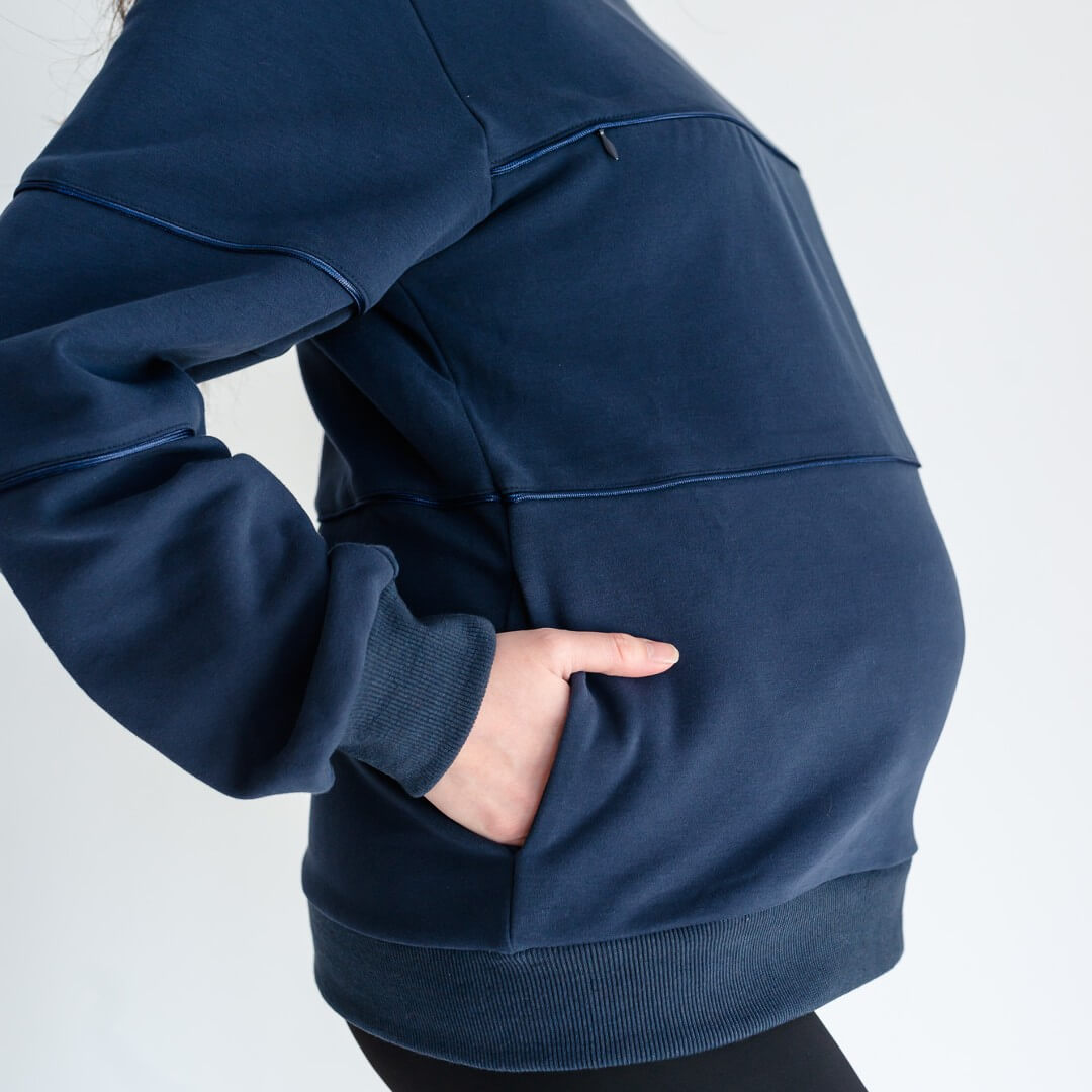 Pregnant woman wearing midnight blue warm zipper breastfeeding sweatshirt from Joyleta maternity store Canada.