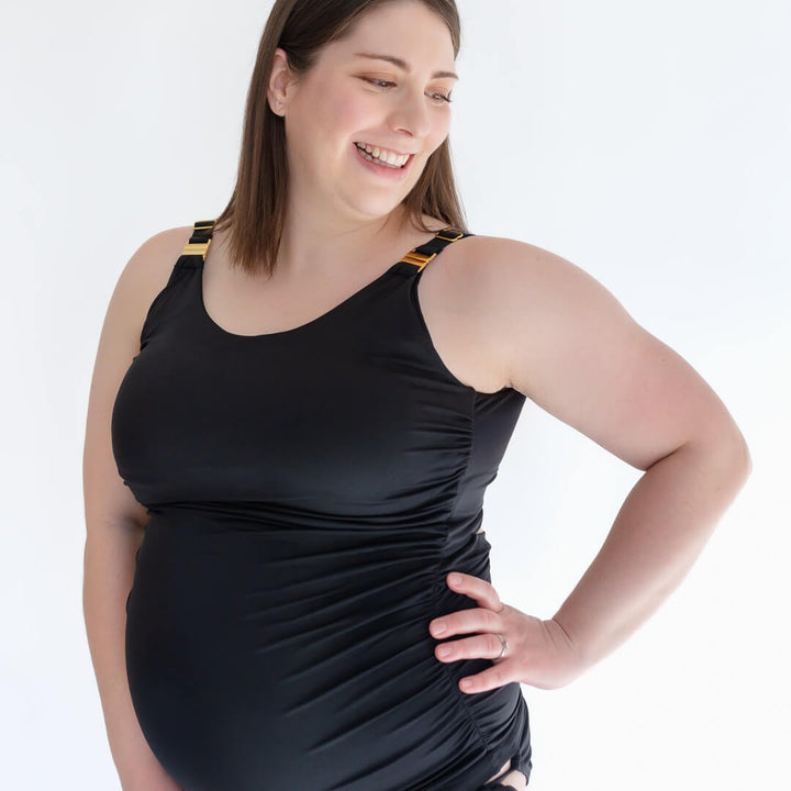 Pregnant woman wearing black maternity bathing suit from Joyleta, a Canadian maternity activewear company.