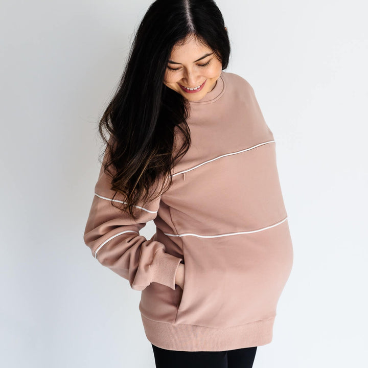 Pregnant woman wearing warm zipper breastfeeding sweatshirt in PinkTaupe color from Joyleta (maternity store in Canada).