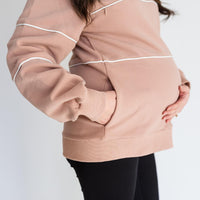 Pregnant woman wearing warm zipper breastfeeding sweatshirt with pockets in PinkTaupe.