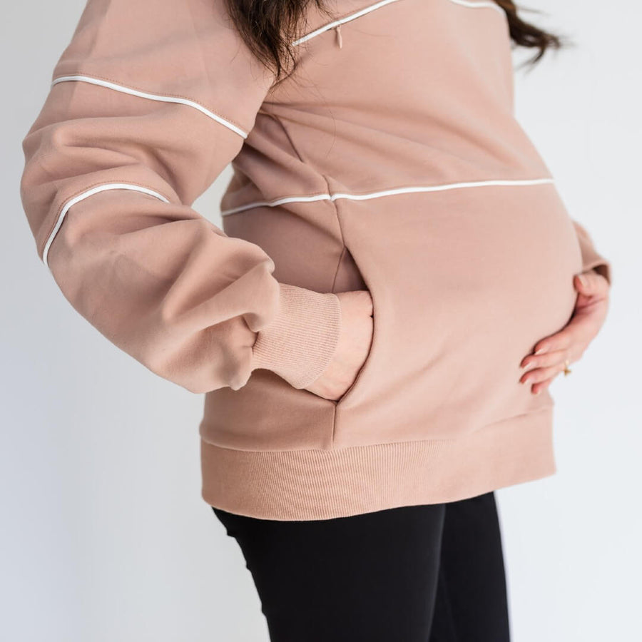 Pregnant woman wearing warm zipper breastfeeding sweatshirt with pockets in PinkTaupe.