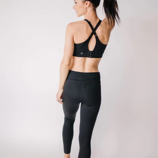 Mom wearing black front-zip nursing sports bra and black maternity workout leggings from a maternity and nursing activewear company in Canada - Joyleta