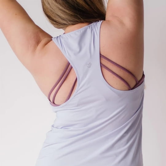 Mother showing back of maternity and nursing tank top and strappy nursing sports bra