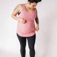 Mother wearing long maternity workout tank top in dusty rose and black maternity leggings.