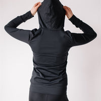Woman showing back of black maternity leggings and black nursing hoodie from Joyleta maternity store Canada.