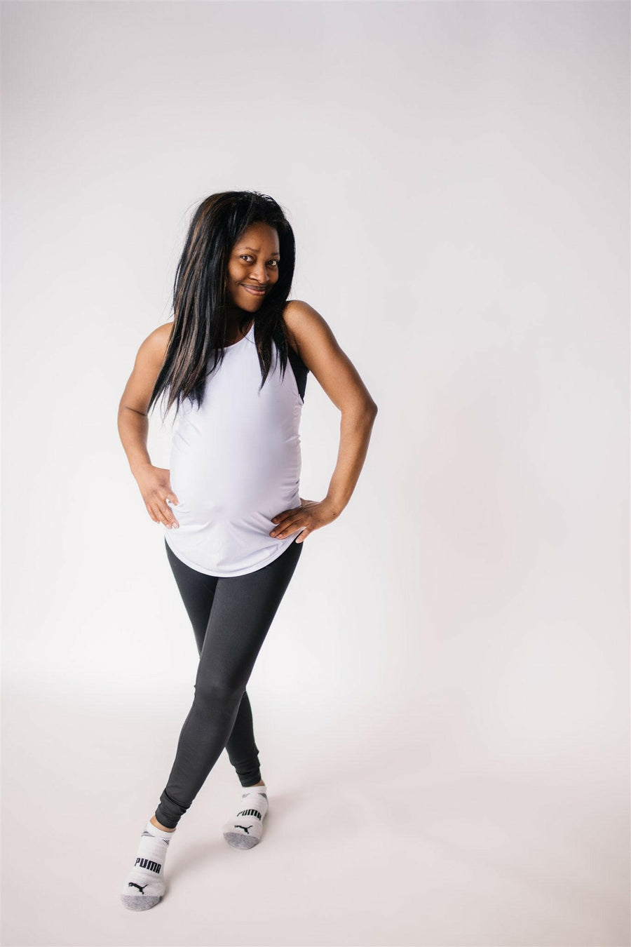 Woman wearing long maternity tank top in lavender.