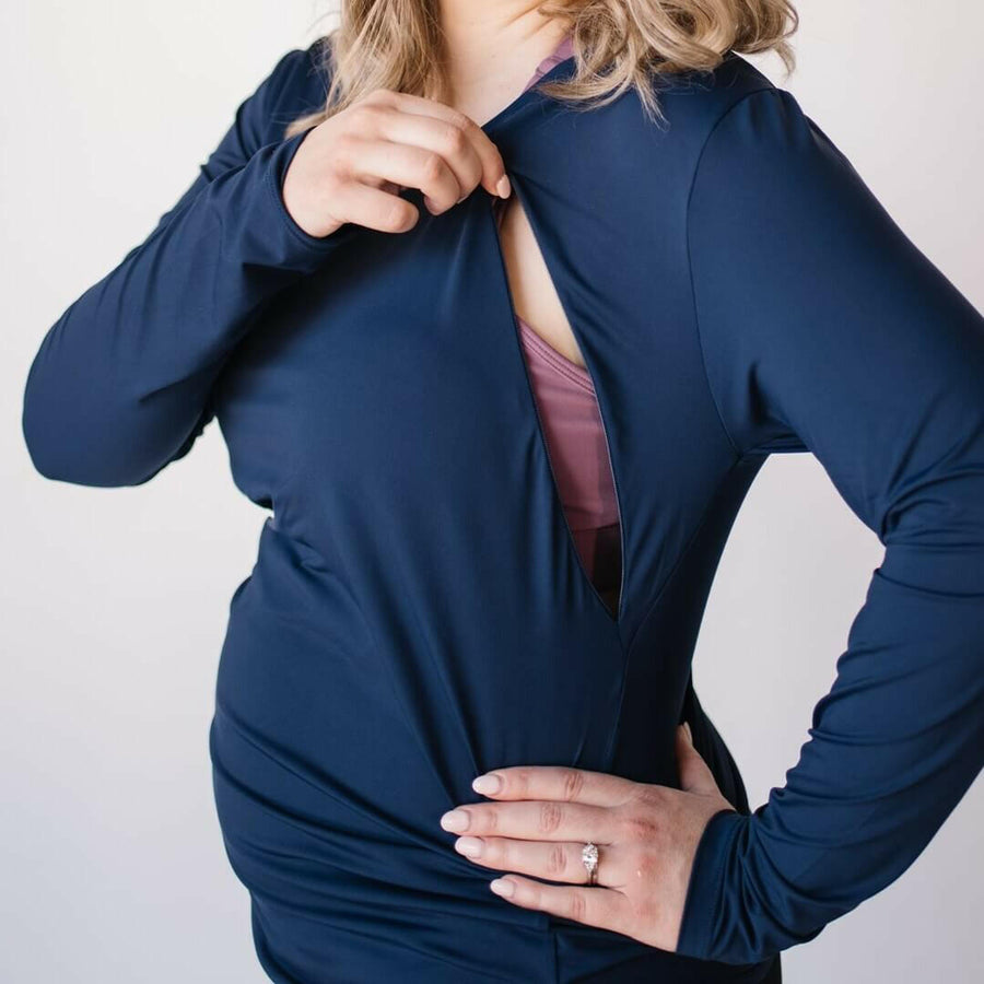 Woman wearing long maternity and nursing long sleeve top with invisible nursing zippers, in midnight blue.